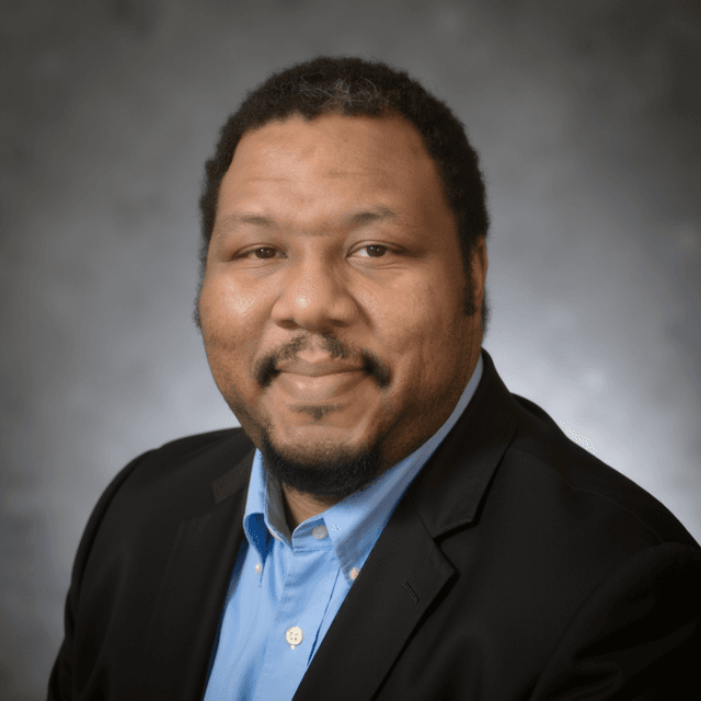 Professional headshot of John Spriggs